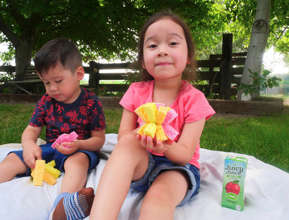 Young children palying with their resuable sponge water balloons