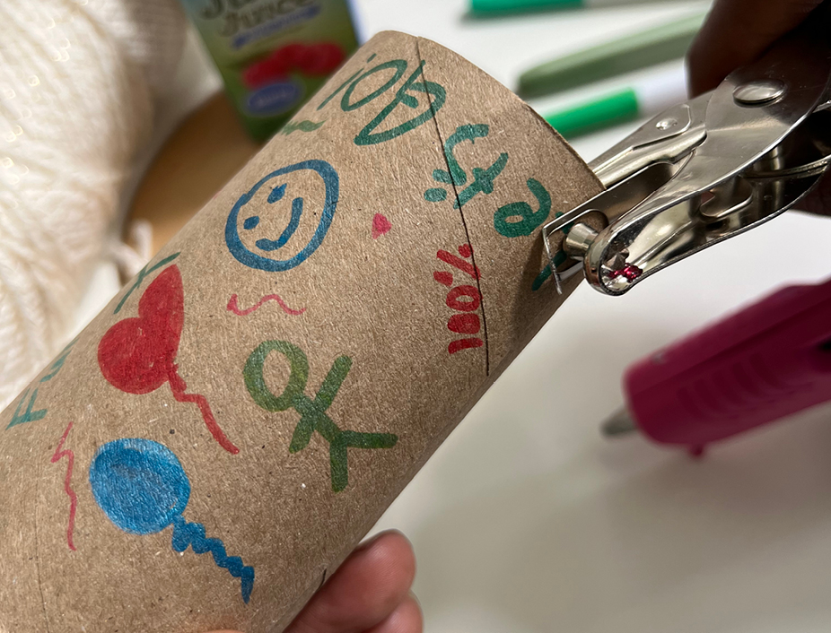 hole punching the binuculars/paper roll