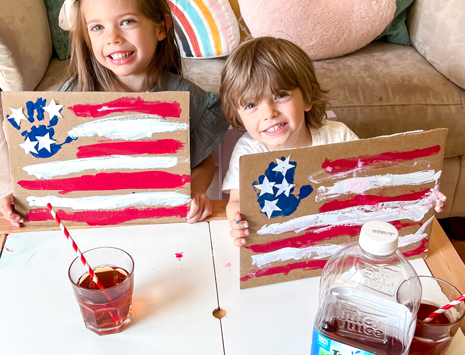 Kids holding up their final cardboard flags