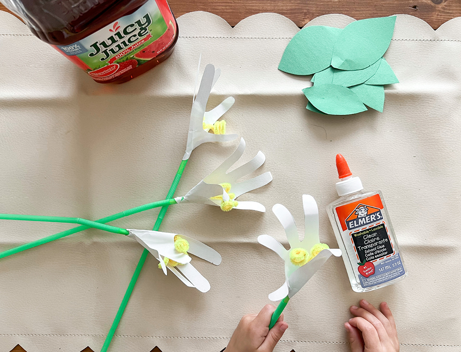 Take your handprints and wrap them from pinky to thumb around the end of the green straw so your yellow pistil is just at the center. 