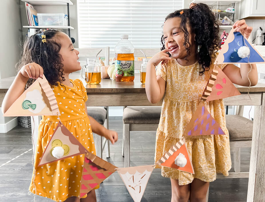 Young girls holding up their pie garland
