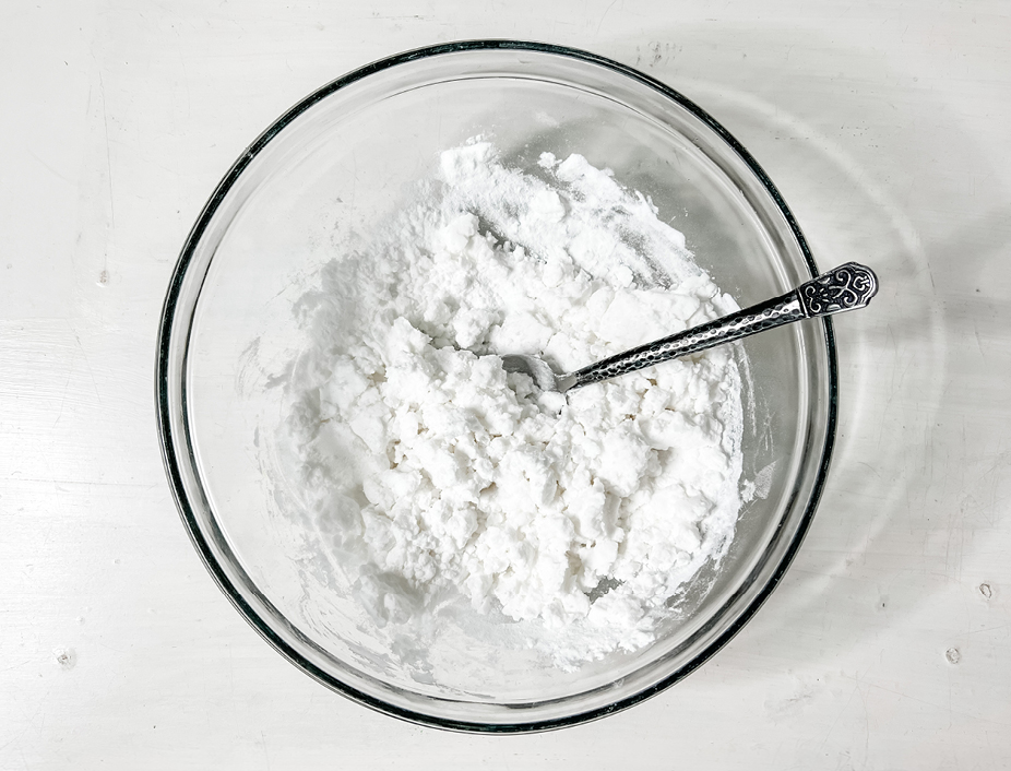 homemade snow process started by mixing the conditioner and baking soda until a ball forms