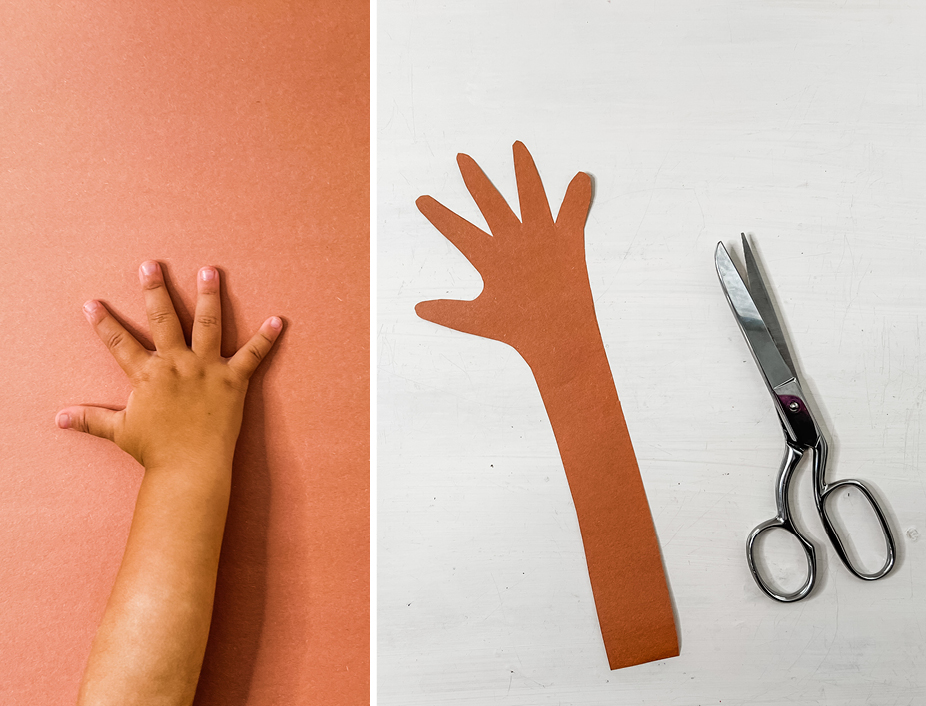 construction paper cutout of a childs arm and hand for the tree branch